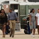 TOPSHOT - US President Barack Obama, First Lady Michelle Obama and daughters Malia and Sasha walk to board Air Force One at Cape Cod Air Force Station in Massachusetts on August 21, 2016 as they depart for Washington after a two-week holiday at nearby Martha’s Vineyard.